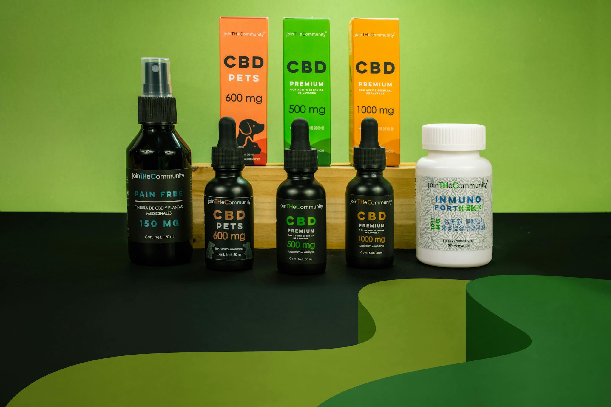 Array of CBD products including oils and supplements on a green background.