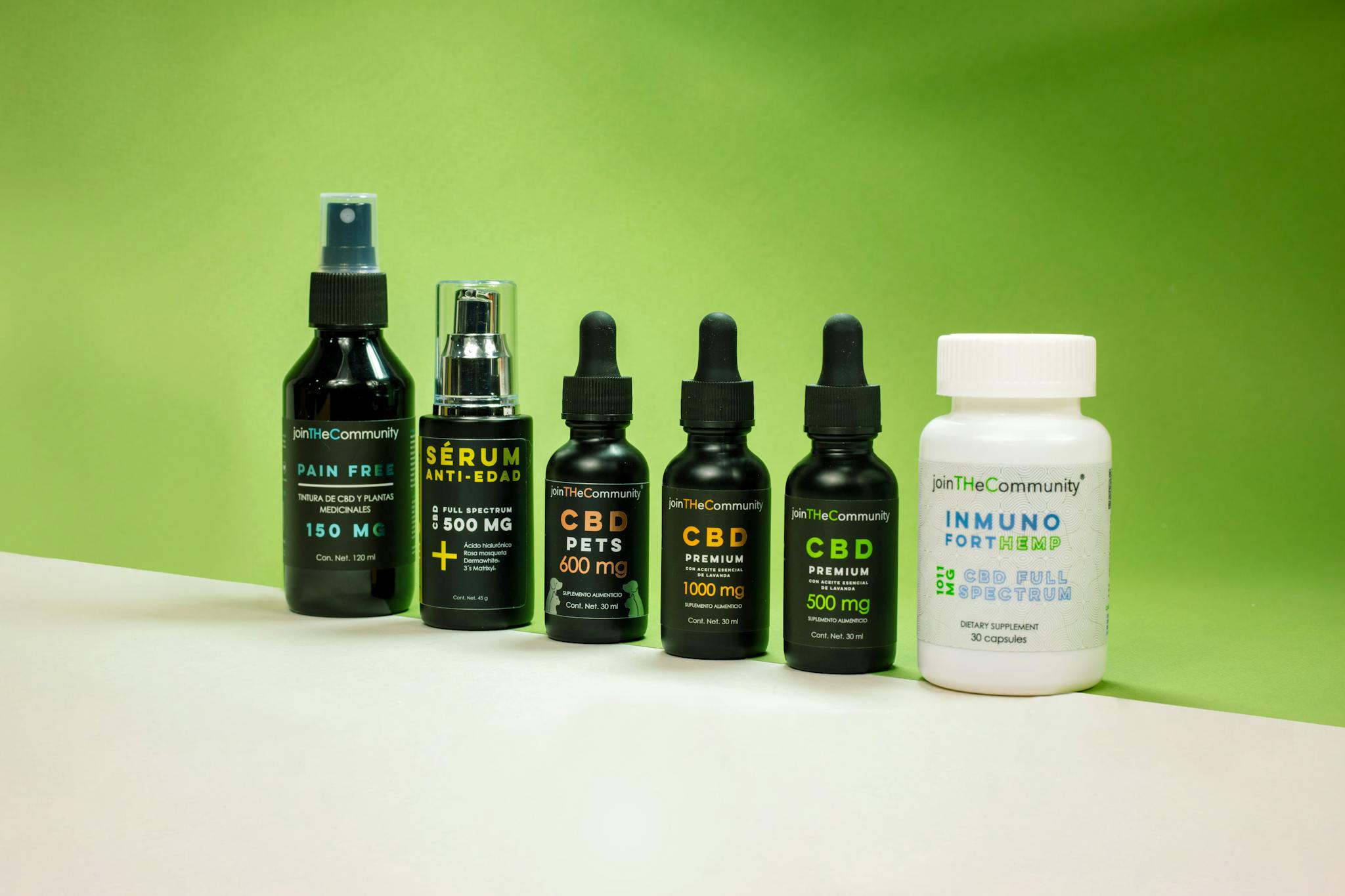 Collection of CBD products including serums and supplements displayed against a green backdrop.